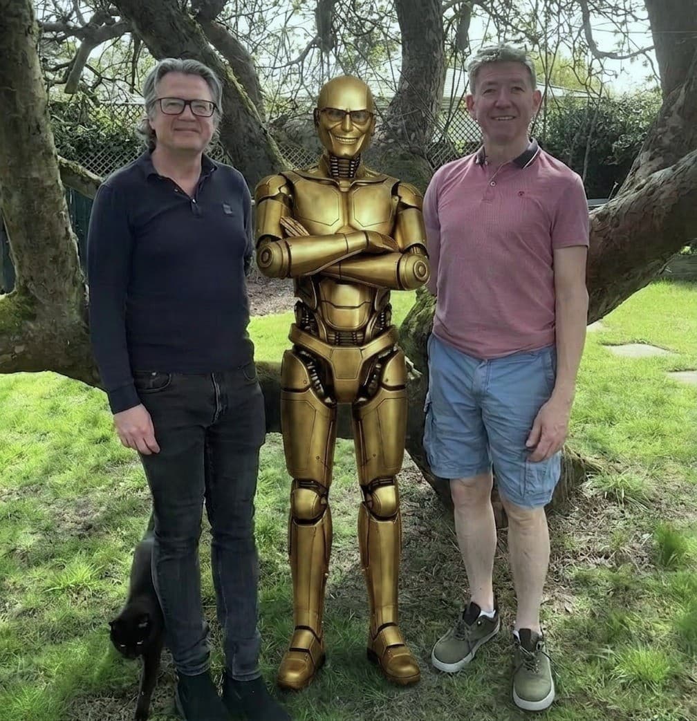 Jez and James with an AI robot mascot